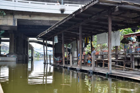 BANGKOK, THAILAND - MARCH 30, 2013: canal boat on Klong Saen Saep arrives for passengers waiting on a pierのeditorial素材