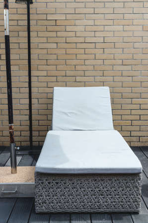 White couch beside the pool. The rear wall Brownの写真素材