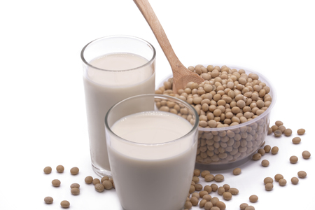 Soy beans on white background high protein Close-up Selective focus seeds Soya bean pulses in a wooden spoon (Glycine max (L.) Merr.)の写真素材