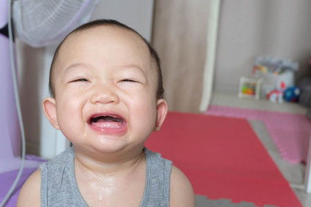 Portrait of cute asian baby boy having fun at home.