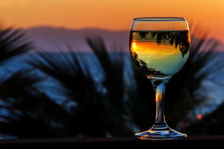 white wine on the sunset sea background in aprilの写真素材