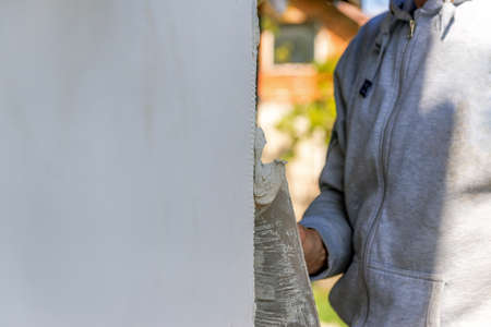 applying putty to the polyfoam wallの写真素材