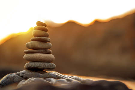 Stones Balance in sunrise at sea in aprilの写真素材
