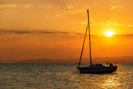 A beautiful sunset and a boat on the beachの写真素材
