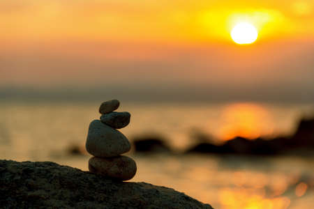 Stones Balance in sunrise at sea in augustの写真素材