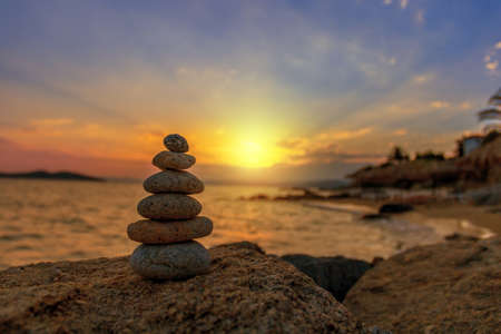 Stones Balance in sunrise at sea in augustの写真素材