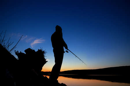 fishing at sunset near the sea in summerの写真素材