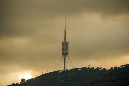 Telecommunications tower in stormy skyの写真素材