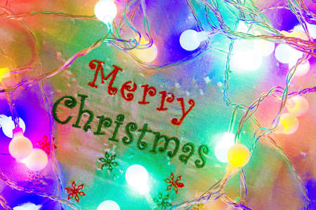 Merry Christmas Greeting with Glowing Colorful Christmas Lightsの写真素材