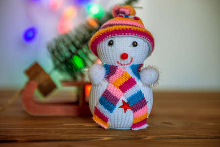 Snowman figurine.Blurry Christmas lights out of focus in the background. Bokehの写真素材