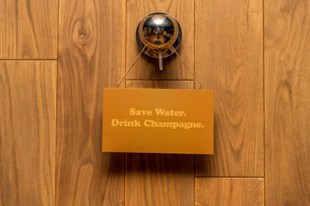 Wooden background with plate. Save water. Drink Champagne.Concept for the sale of woodの写真素材