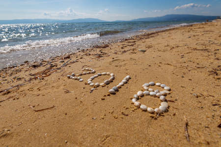 Year 2018 handwritten on seashore sand.の写真素材