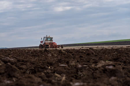 Tractor plowing fields. Preparing land for sowing in autumn.の写真素材