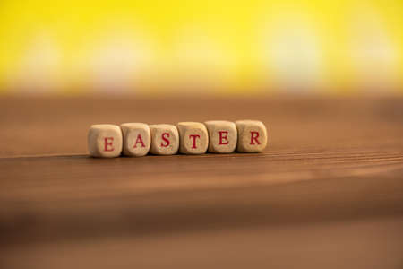 Text Happy Easter on a wooden blackboard in spring.の写真素材