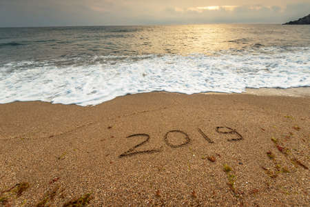 2019 year on the sea sand shore at sunset.の写真素材