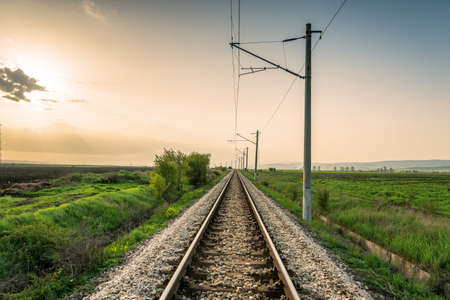 Landscape of an old abandoned railway at the sunrise. Sunny summer day.の写真素材