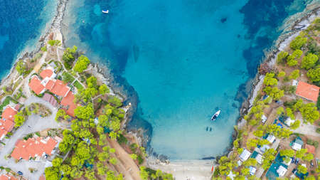 Aerial sunset view of amazing Neos Marmaras cityscape and distant turtle island in Greece.