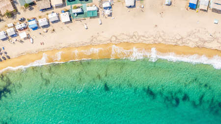 Aerial View From Flying Drone Of People Crowd Relaxing On Beach In Greece.