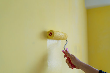 Decorator's hand painting wall with roller.の写真素材