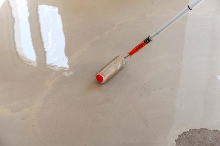 Needle roller for self-leveling floors. Leveling the floors with a cement mixture.の写真素材