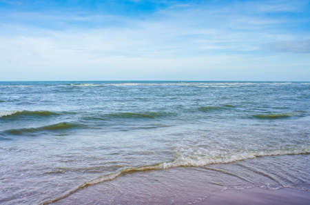 Sea waves on the sand beach with blue sky, concept for background texture.の写真素材