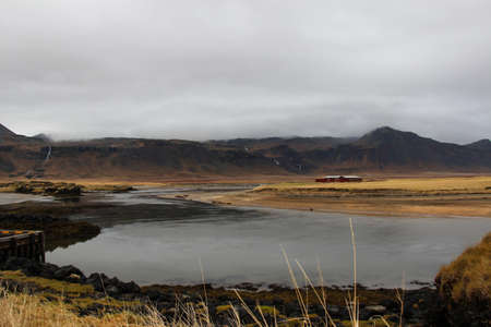 Landscape view of the big mountain and the grass field on the way to Reykholt, autumn Iceland