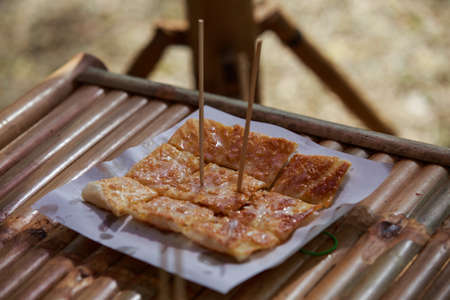 Fried bread with egg on the bamboo tableの写真素材