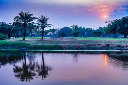 Sunset at the golf course lake.の写真素材