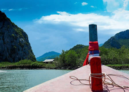 Front view of a wooden fishing boat with blue sky backgroundの写真素材