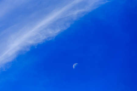 Beautiful blue sky with the Moon and white cloud, concept for background texture.の写真素材