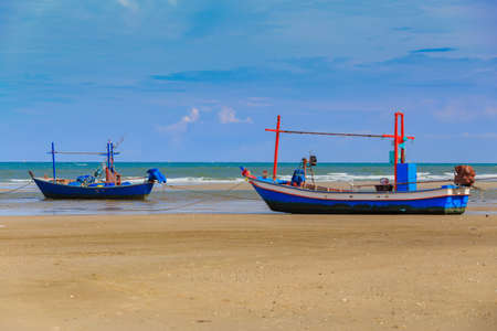 Wooden fishing boat parking on a sandy beachの写真素材