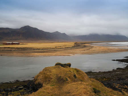 Landscape view of the big mountain and the grass field on the way to Reykholt, autumn Icelandの写真素材