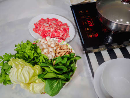 Sliced beef and vegetables with hot pot set, ready to serve for shabu menuの写真素材