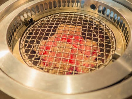 Hot barbecue fire with red glowing coals ready to grill. Empty hot charcoal grill with flame.の写真素材