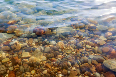 Close up of colored stones under salty water at the Dead Sea coast, Jordan.の写真素材
