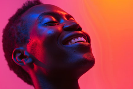 A man with a big smile on his face. He is wearing a black shirt and has a beardの素材