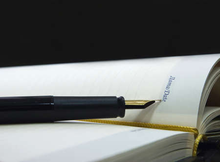 The opened notebook with pen  which feather is specified in an inscription by""Date"
の写真素材
