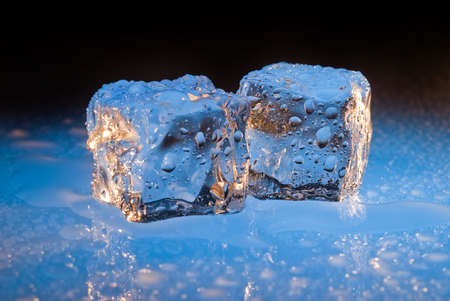 Cool blue ice cubes dripping waterの写真素材