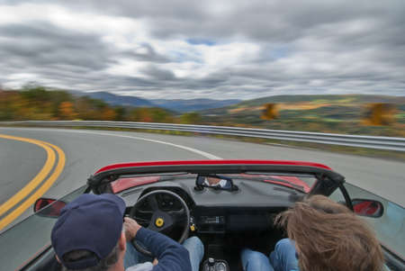 driving an italian sportscar at speed on a country roadの写真素材