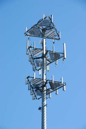 Close up of cell tower against blue skyの写真素材