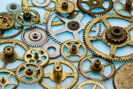 various old clock gears overlapping on a blue backgroundの写真素材