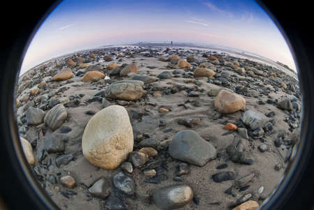 Fisheye view of low tide on rocky beachの写真素材
