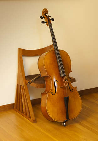 Cello or violincello, resting on chair with bowの写真素材