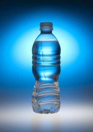 Water bottle back lit by blue lightの写真素材