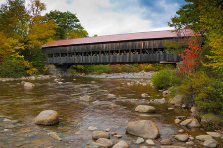 New England covered bridge during the fall seasonの写真素材