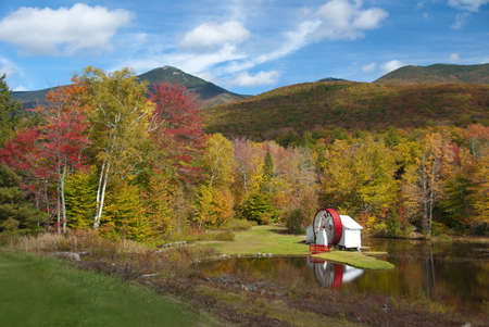 Scenic fall view of New Hampshire water mill on pondの写真素材