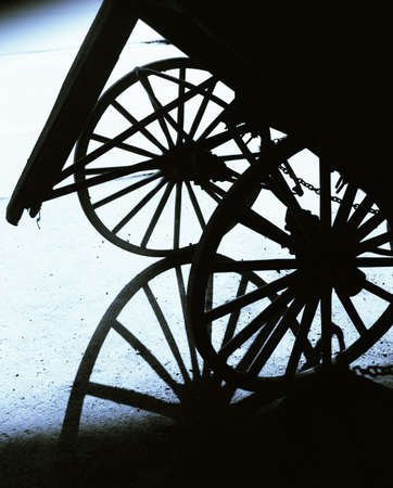 Graphic shot of two wagon wheels and shadowの写真素材