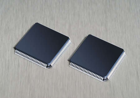 Two computer chips on stainless steel backgroundの写真素材