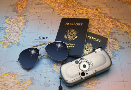 Map of sunny Italy with Two American passports, sun glasses and cameraの写真素材