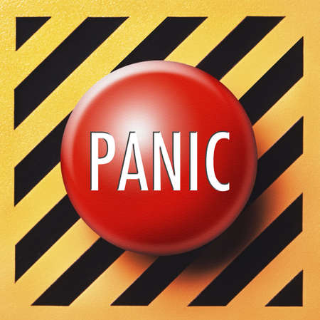 Panic button in red on yellow and black panel の写真素材